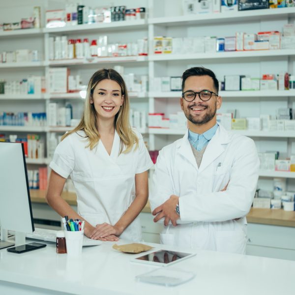 happy-young-male-and-female-colleagues-pharmacist-working-in-a-pharmacy.jpg